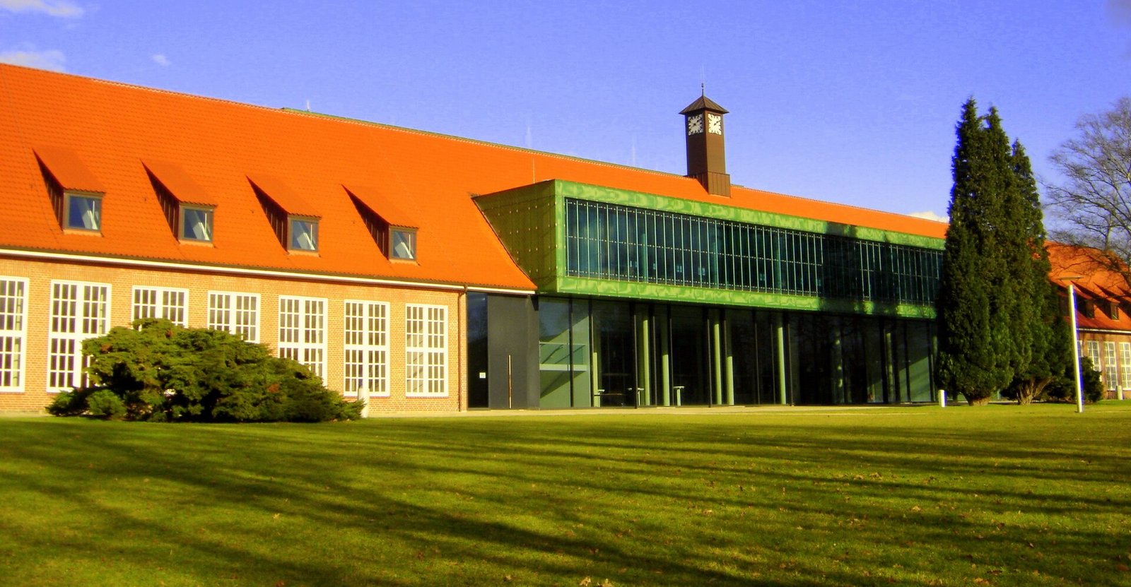 Modern campus building with green accents